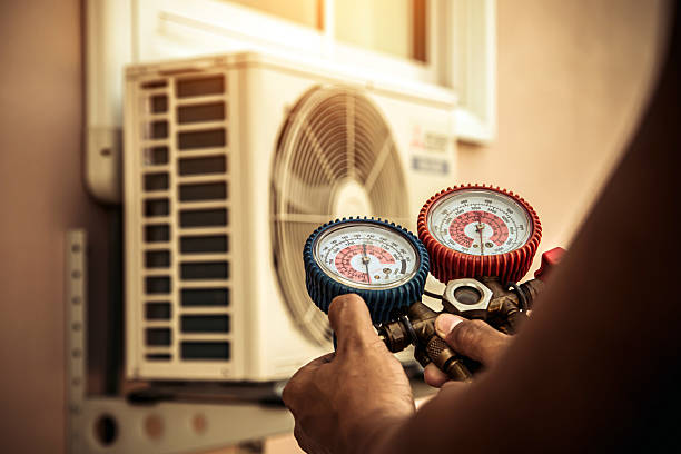 Professional Air Conditioning Service technician working in Ridgeville, IN